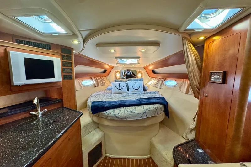 Escape Yacht Photos Pics Luxurious interior of 2009 Rinker 360 Express Cruiser with cozy bed and modern amenities.