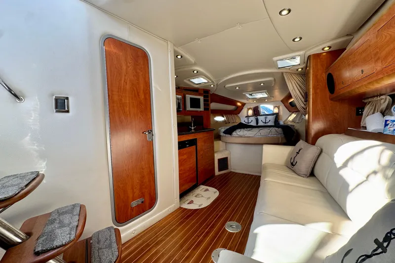 Escape Yacht Photos Pics 2009 Rinker 360 Express Cruiser interior with cozy seating, wood accents, and nautical decor.