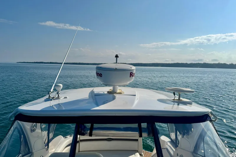 Escape Yacht Photos Pics 2009 Rinker 360 Express Cruiser on calm water, clear sky, radar equipment visible.