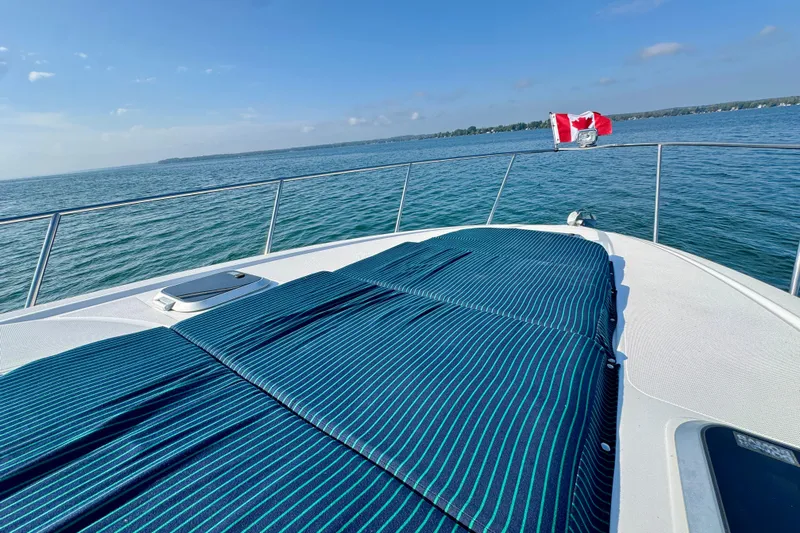 Escape Yacht Photos Pics 2009 Rinker 360 Express Cruiser on water, featuring sun deck and Canadian flag.
