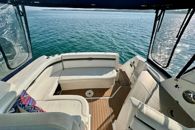 Escape Yacht Photos Pics 2009 Rinker 360 Express Cruiser interior with white seating and scenic ocean view.