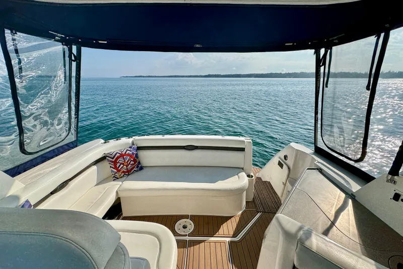 Escape Yacht Photos Pics 2009 Rinker 360 Express Cruiser interior with ocean view, featuring comfortable seating and nautical decor.