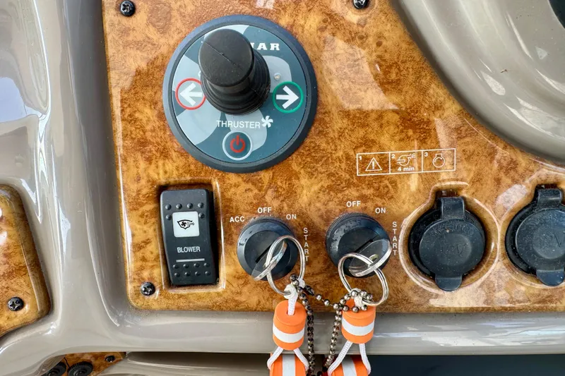 Escape Yacht Photos Pics Control panel of a 2009 Rinker 360 Express Cruiser with keys and thruster controls.