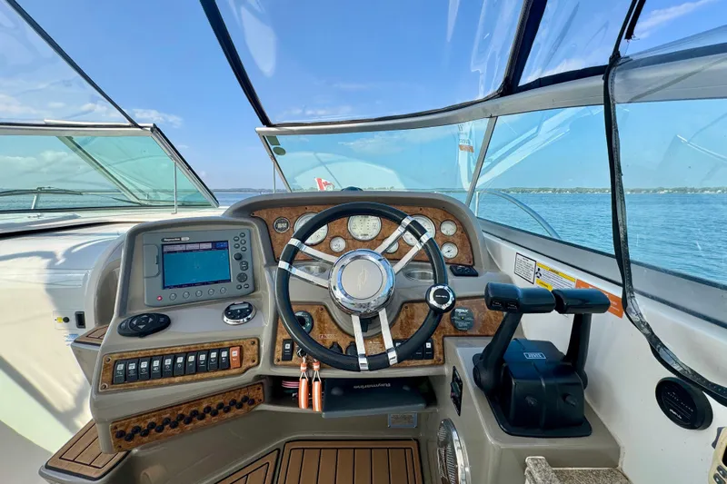 Escape Yacht Photos Pics 2009 Rinker 360 Express Cruiser helm with navigation controls and steering wheel.