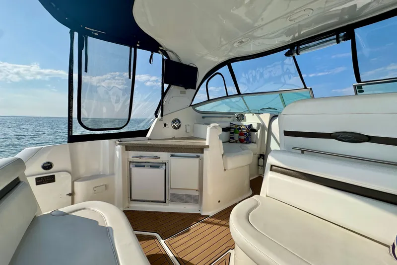 Escape Yacht Photos Pics 2009 Rinker 360 Express Cruiser interior with seating, kitchenette, and ocean view.