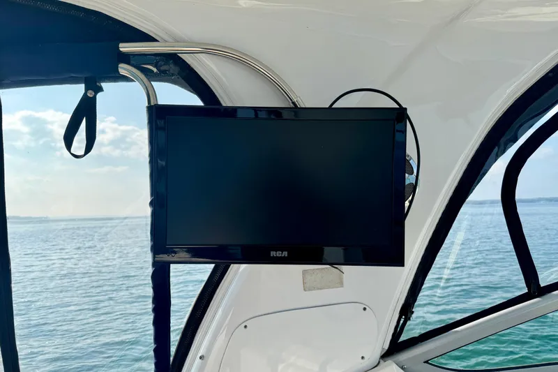 Escape Yacht Photos Pics Rinker 360 Express Cruiser 2009 interior with mounted RCA TV, ocean view.