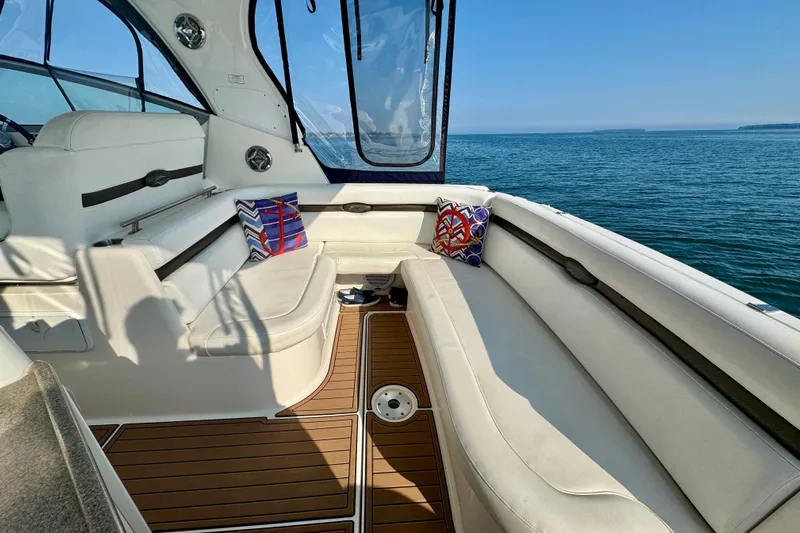 Escape Yacht Photos Pics 2009 Rinker 360 Express Cruiser interior with white seating, wooden flooring, and ocean view.