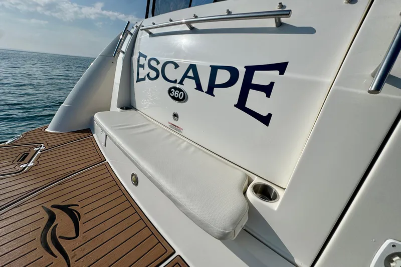Escape Yacht Photos Pics 2009 Rinker 360 Express Cruiser, rear view with "Escape" name, on calm water.
