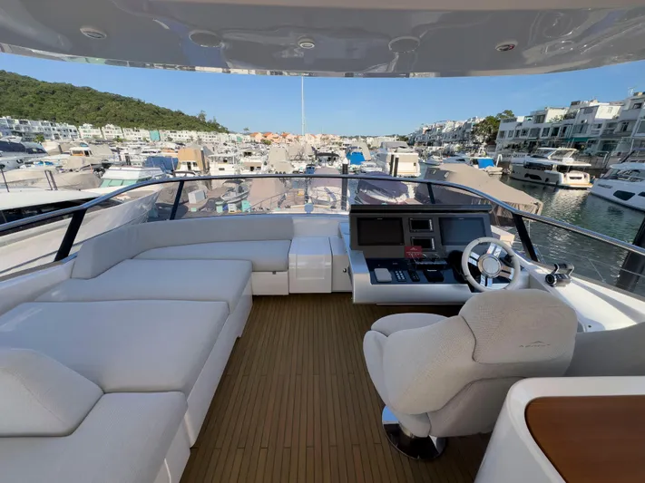  Yacht Photos Pics Luxurious 2020 Azimut GRANDE 25 METRI yacht interior with helm and seating area in marina.