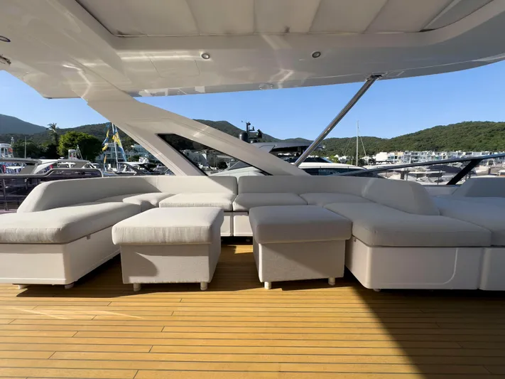  Yacht Photos Pics Luxurious seating area on 2020 Azimut GRANDE 25 METRI yacht, docked with scenic mountain backdrop.