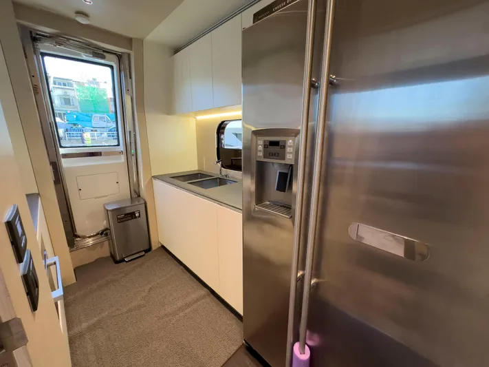 Yacht Photos Pics Modern kitchen interior on 2020 Azimut GRANDE 25 METRI yacht, featuring stainless steel appliances.