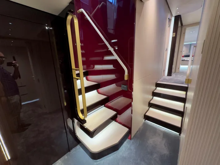  Yacht Photos Pics Luxurious interior staircase of 2020 Azimut GRANDE 25 METRI yacht, featuring elegant lighting.