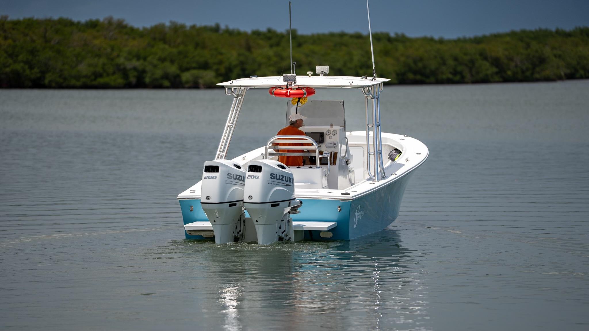 2021 C-Hawk 29CC boat with dual Suzuki engines on calm water.