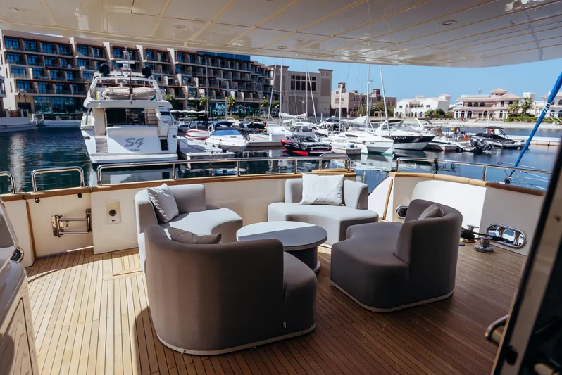 Apache Yacht Photos Pics Luxurious Falcon 86 yacht deck with modern seating, overlooking a marina, 2004 model.