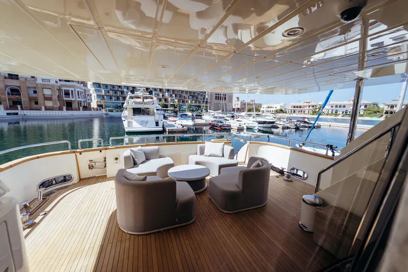 Apache Yacht Photos Pics Luxurious Falcon 86 yacht deck with seating, overlooking marina, 2004 model.