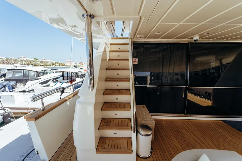 Apache Yacht Photos Pics Staircase on a 2004 Falcon 86 yacht with wooden deck and railing.