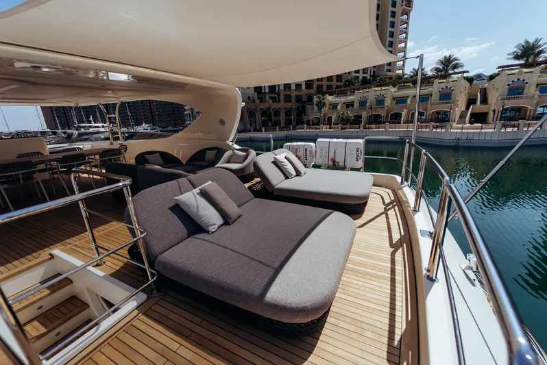 Apache Yacht Photos Pics Luxurious Falcon 86 yacht deck with sun loungers, docked at a marina, 2004 model.