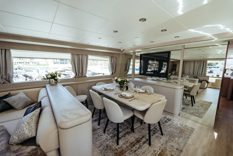 Apache Yacht Photos Pics Luxurious interior of 2004 Falcon 86 yacht with elegant dining area and plush seating.