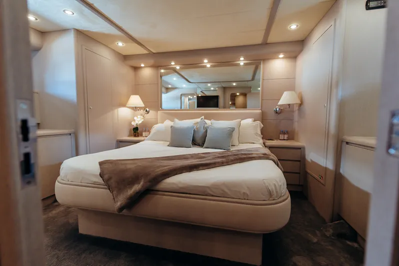 Apache Yacht Photos Pics Luxurious bedroom interior in a 2004 Falcon 86 yacht, featuring elegant lighting and cozy bedding.