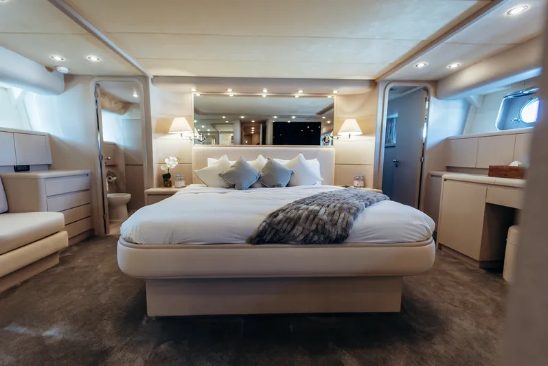 Apache Yacht Photos Pics Luxurious bedroom interior on a 2004 Falcon 86 yacht, featuring elegant decor and ambient lighting.