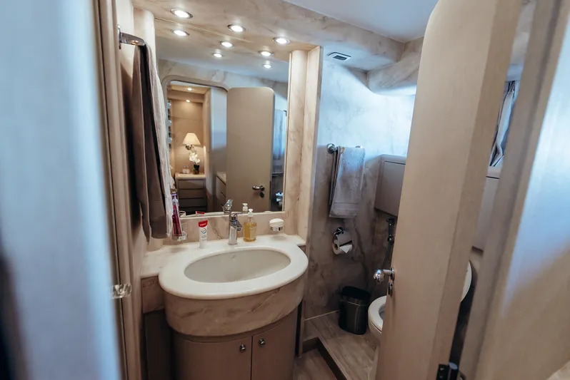 Apache Yacht Photos Pics Luxurious bathroom in 2004 Falcon 86 yacht with modern fixtures and elegant design.