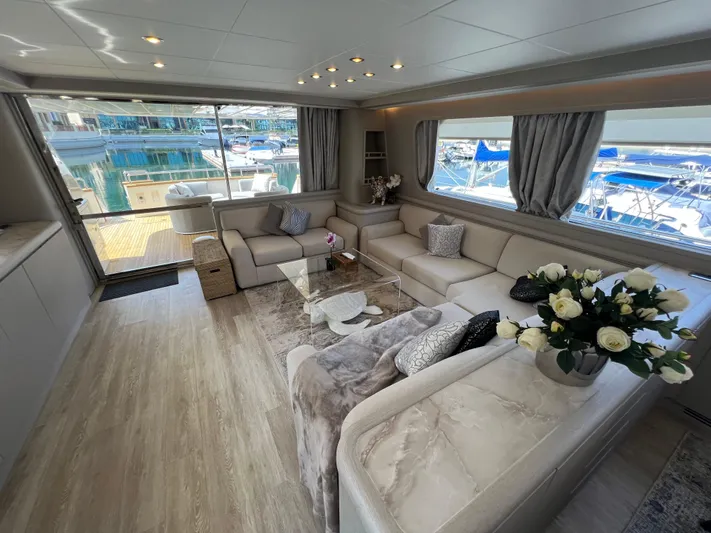 Apache Yacht Photos Pics Luxurious yacht interior with elegant seating, glass table, and marina view. Falcon 86, 2004 model.