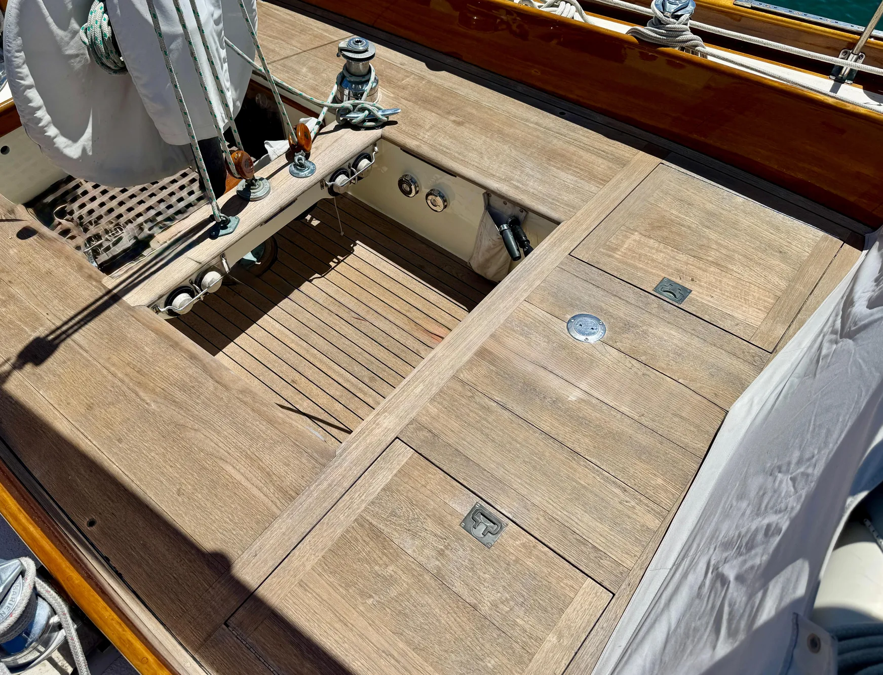 1956 Aage Nielsen 50' Yawl deck with wooden finish and sailing equipment.