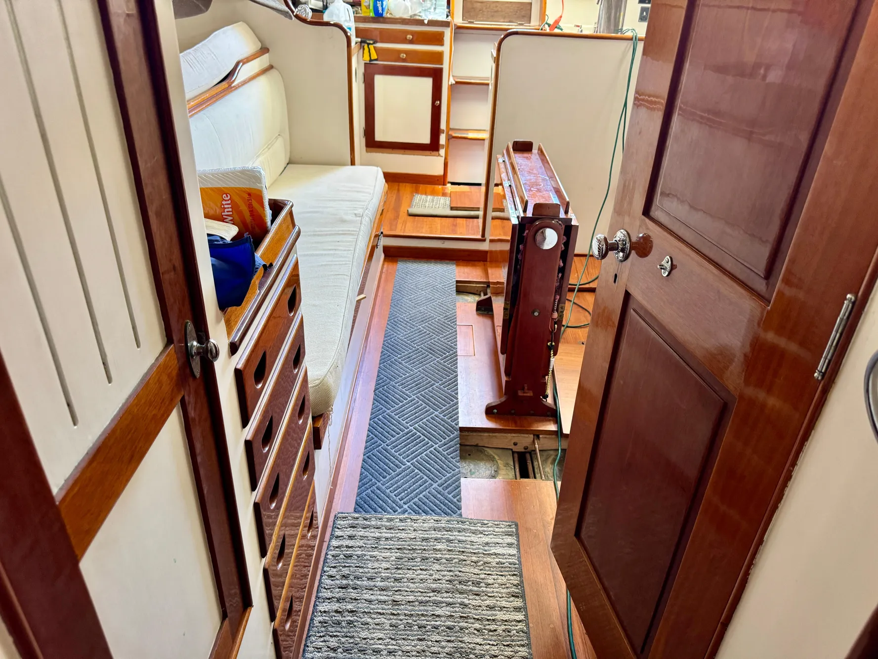 Interior of a 1956 Aage Nielsen 50' Yawl, featuring wooden cabinetry and seating.