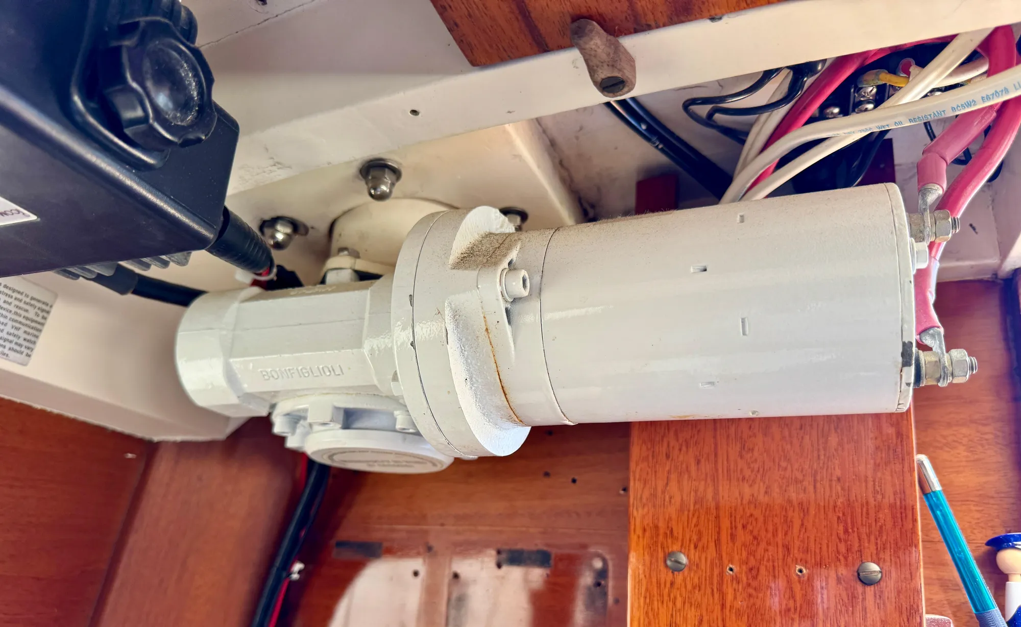 Electrical component inside a 1956 Aage Nielsen 50' Yawl, featuring wiring and wooden paneling.