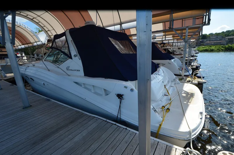 Rehab Is For Quitters Yacht Photos Pics 2003 Sea Ray 420 Sundancer docked at marina, covered with navy blue canopy.