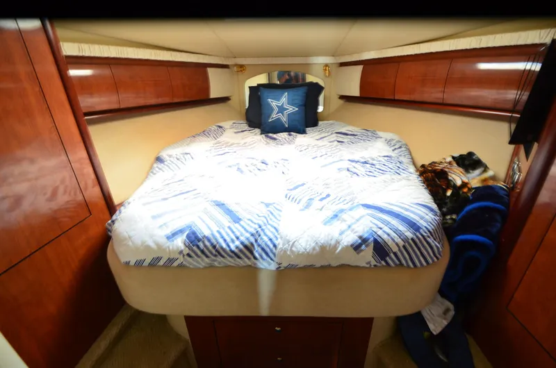 Rehab Is For Quitters Yacht Photos Pics Luxurious cabin interior of 2003 Sea Ray 420 Sundancer with cozy bedding.