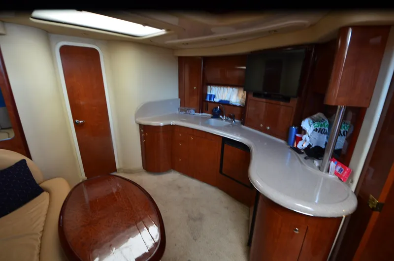 Rehab Is For Quitters Yacht Photos Pics Interior of 2003 Sea Ray 420 Sundancer yacht with modern kitchen and seating area.