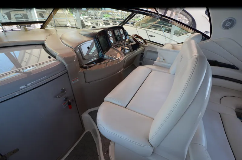 Rehab Is For Quitters Yacht Photos Pics Interior of 2003 Sea Ray 420 Sundancer yacht with white leather seating and control panel.