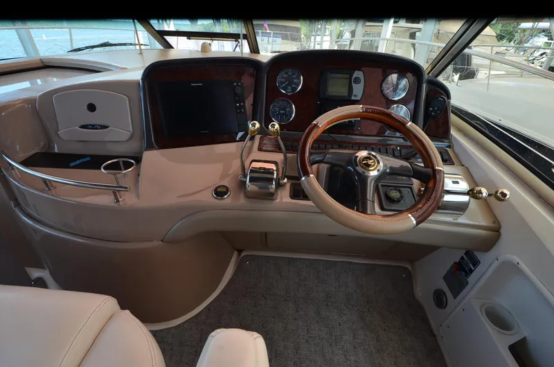 Rehab Is For Quitters Yacht Photos Pics 2003 Sea Ray 420 Sundancer helm with wood-accented steering wheel and modern controls.
