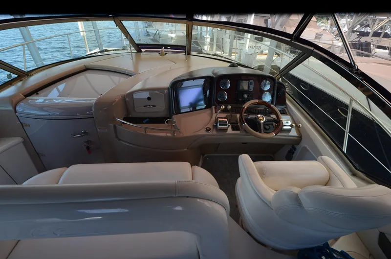 Rehab Is For Quitters Yacht Photos Pics 2003 Sea Ray 420 Sundancer helm with leather seating and modern navigation controls.
