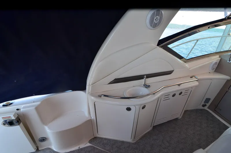 Rehab Is For Quitters Yacht Photos Pics 2003 Sea Ray 420 Sundancer yacht interior with sink and storage cabinets.