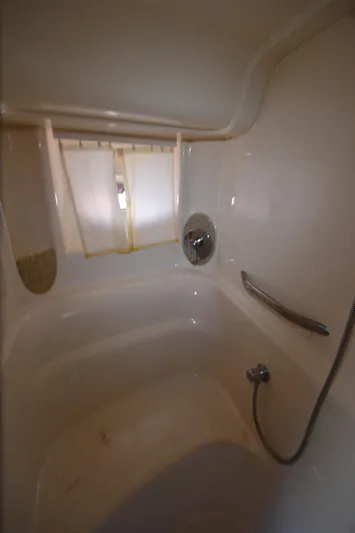 Rehab Is For Quitters Yacht Photos Pics Bathroom interior of 2003 Sea Ray 420 Sundancer yacht, featuring a shower and window.