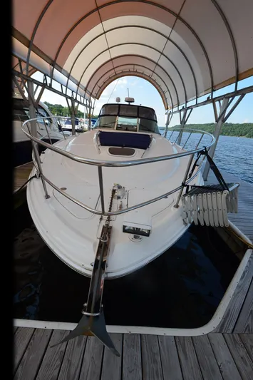 Rehab Is For Quitters Yacht Photos Pics 2003 Sea Ray 420 Sundancer docked under canopy on a sunny day.