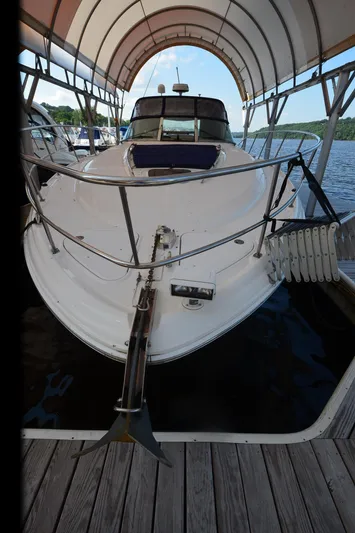 Rehab Is For Quitters Yacht Photos Pics 2003 Sea Ray 420 Sundancer docked under canopy on a sunny day.