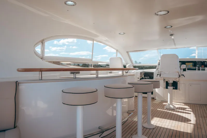 Lady Kristina Yacht Photos Pics Luxurious 2004 Lazzara LY106 yacht interior with bar stools and helm station.