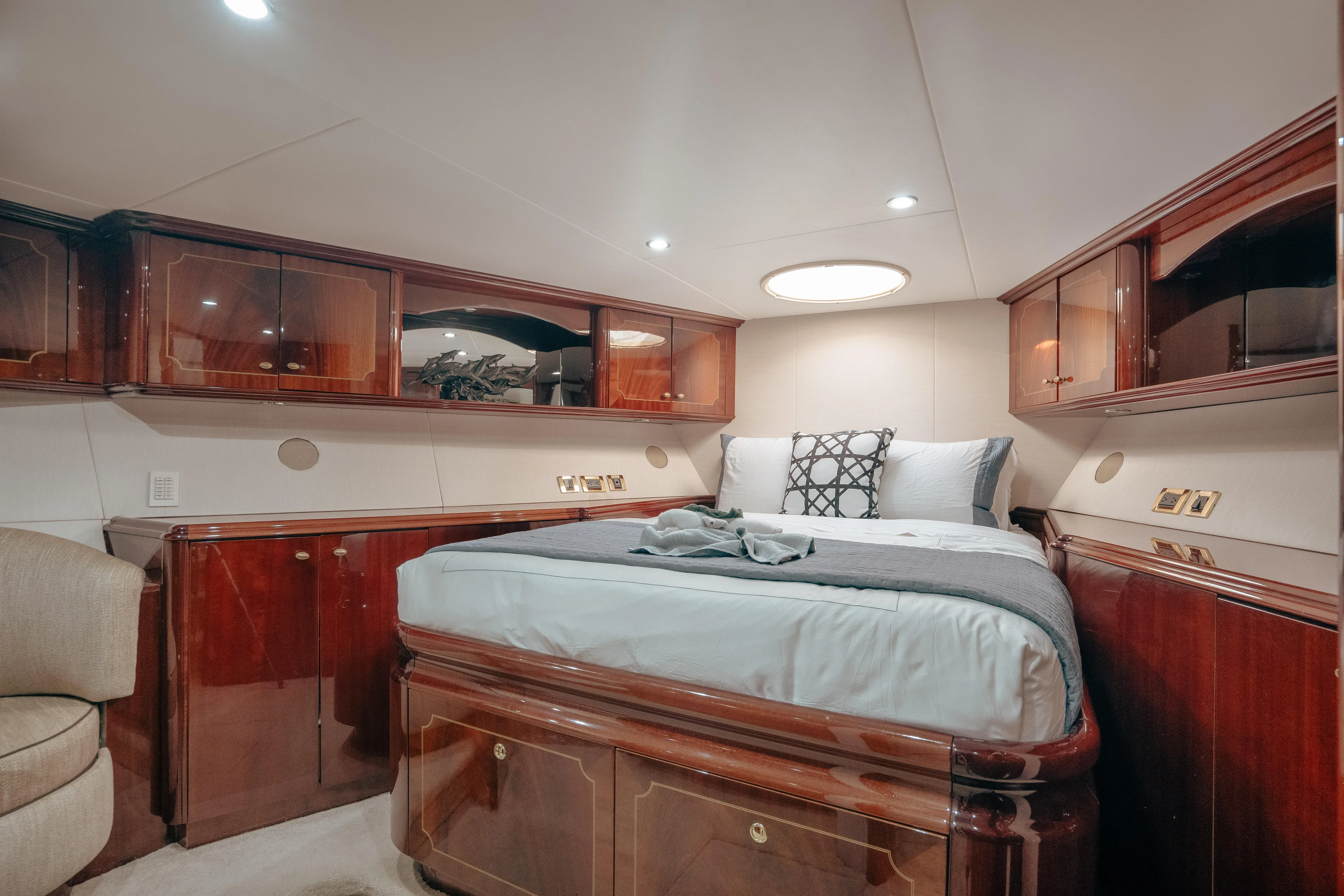 Lady Kristina Yacht Photos Pics Luxurious 2004 Lazzara LY106 yacht bedroom with elegant wood cabinetry and cozy bedding.