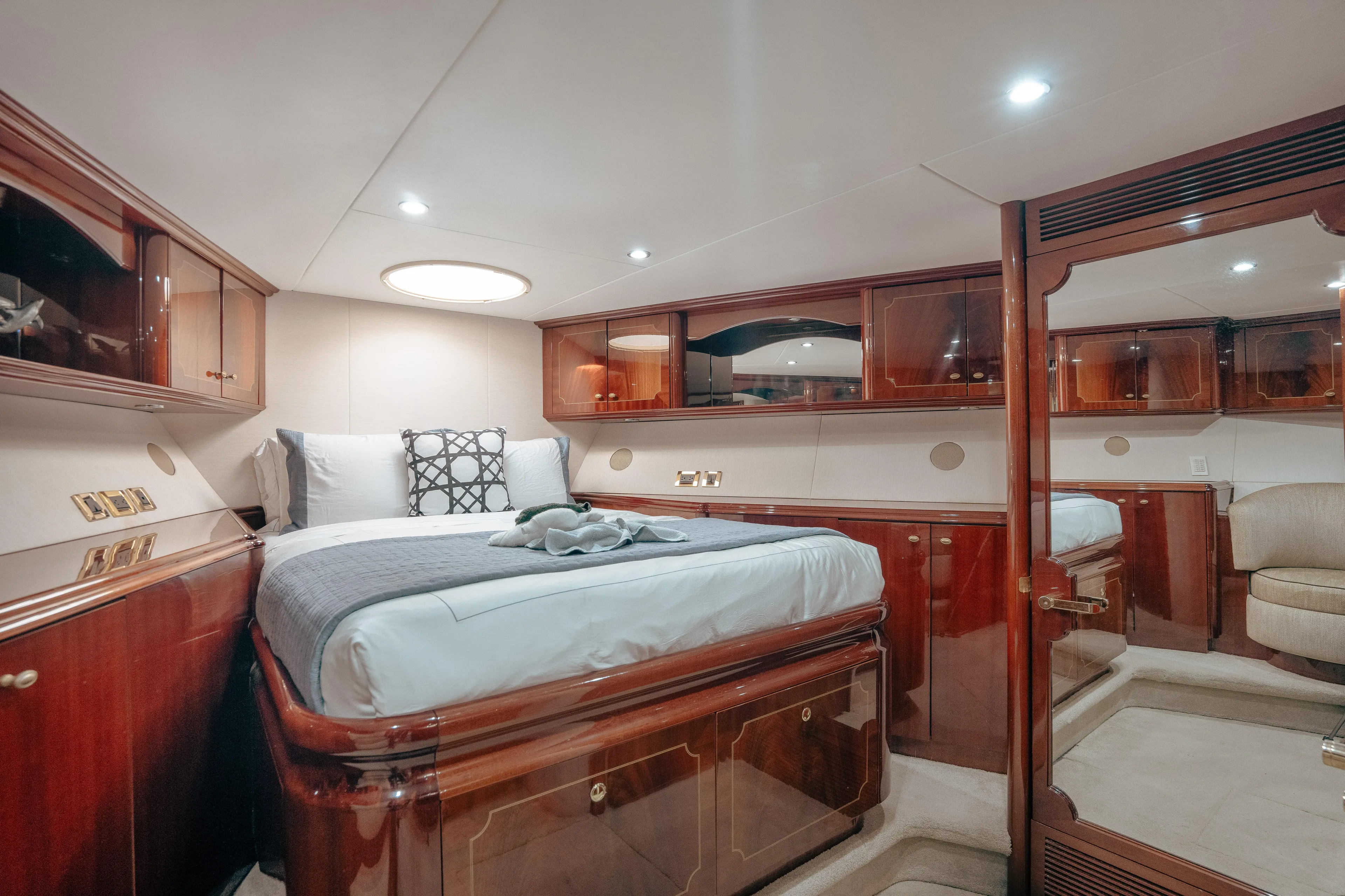 Lady Kristina Yacht Photos Pics Luxurious 2004 Lazzara LY106 yacht bedroom with elegant wood finishes and modern lighting.