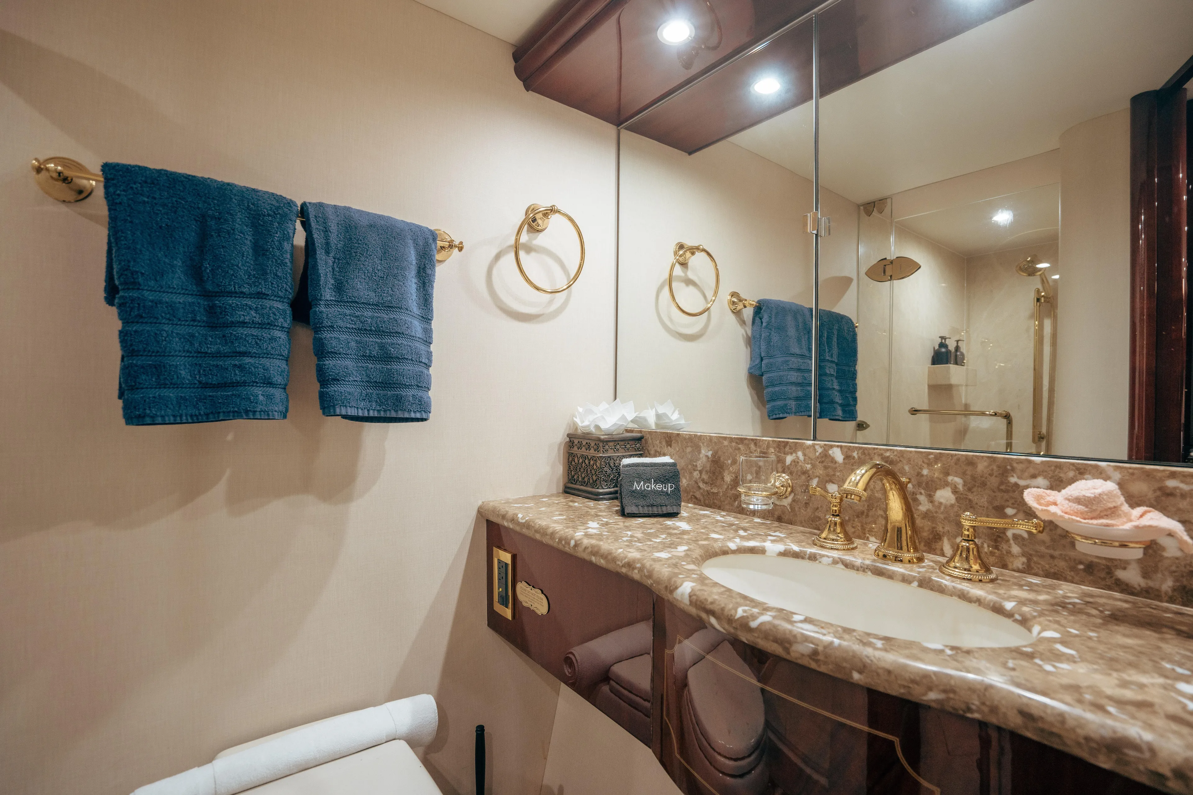 Lady Kristina Yacht Photos Pics Luxurious bathroom in 2004 Lazzara LY106 yacht with marble countertop and gold fixtures.