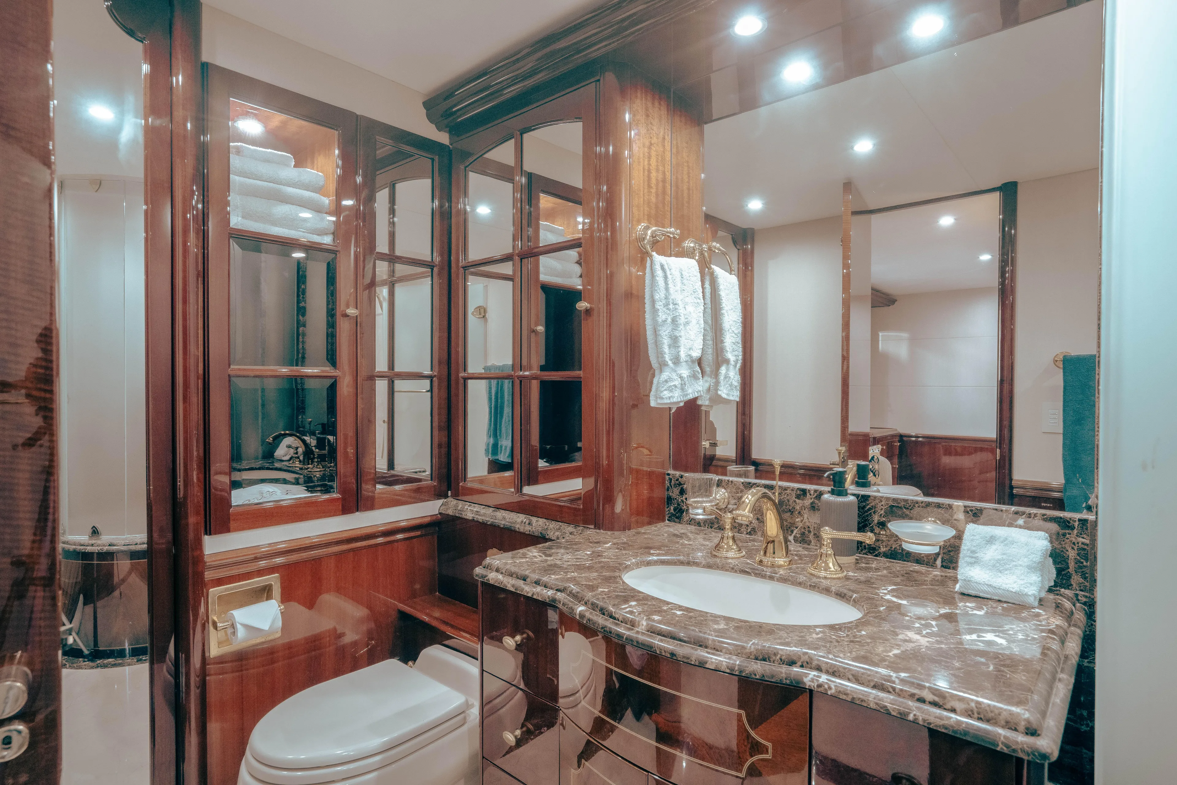 Lady Kristina Yacht Photos Pics Luxurious bathroom in 2004 Lazzara LY106 yacht with marble countertop and elegant wood cabinetry.