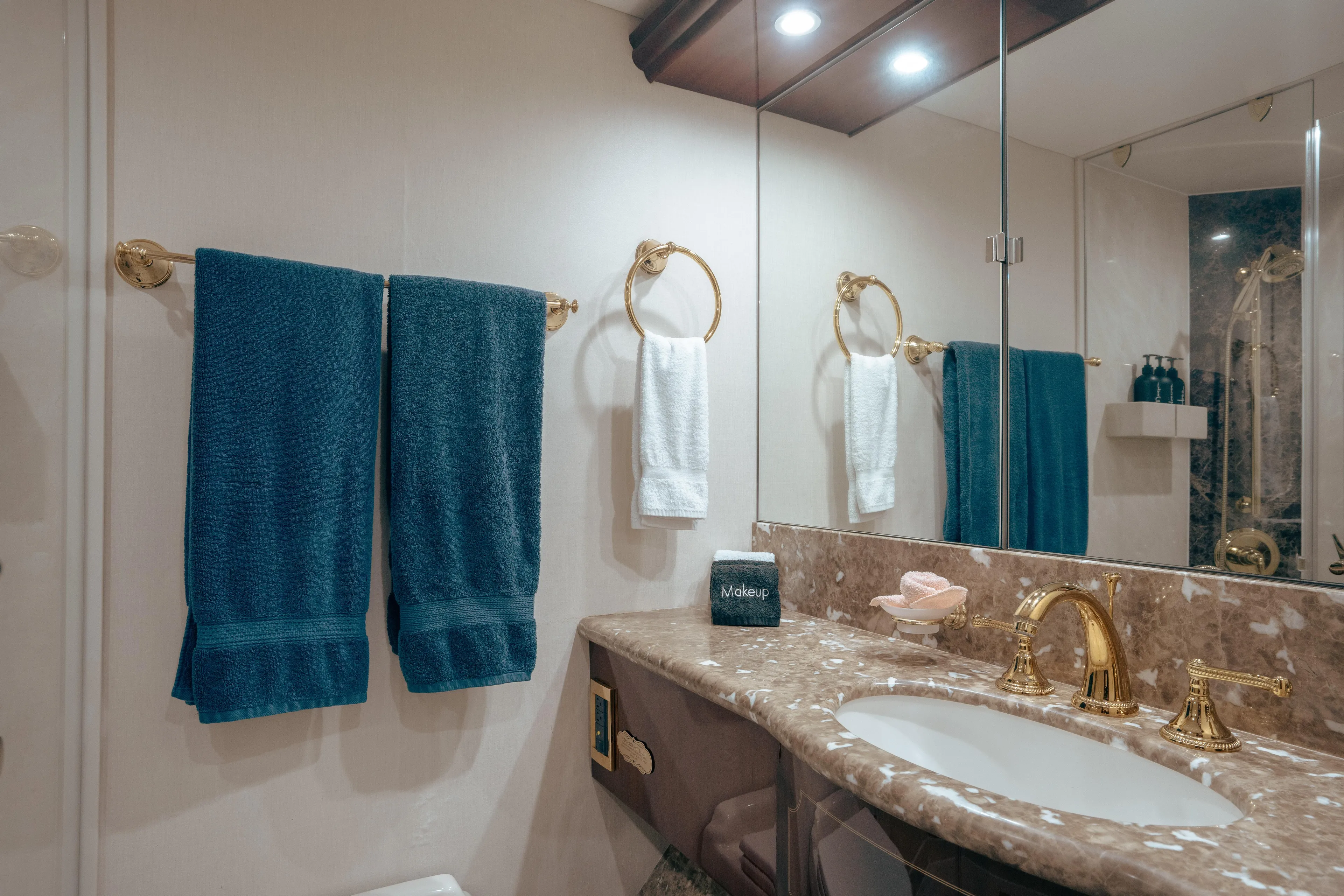 Lady Kristina Yacht Photos Pics Luxurious bathroom in 2004 Lazzara LY106 yacht with marble countertop and gold fixtures.