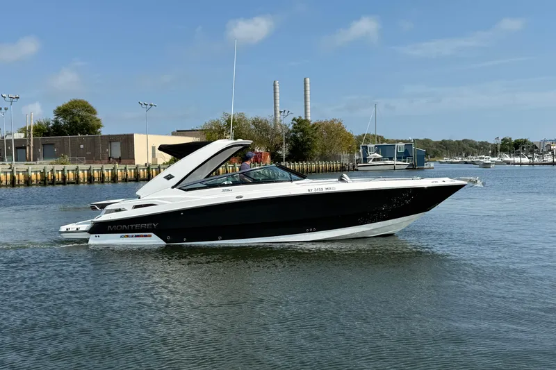  Yacht Photos Pics 2018 Monterey 328SS Super Sport boat cruising in a marina under a clear blue sky.
