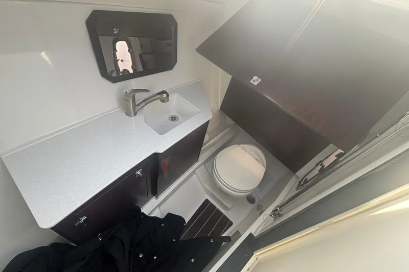  Yacht Photos Pics 2018 Monterey 328SS Super Sport boat bathroom with sink, mirror, and toilet.