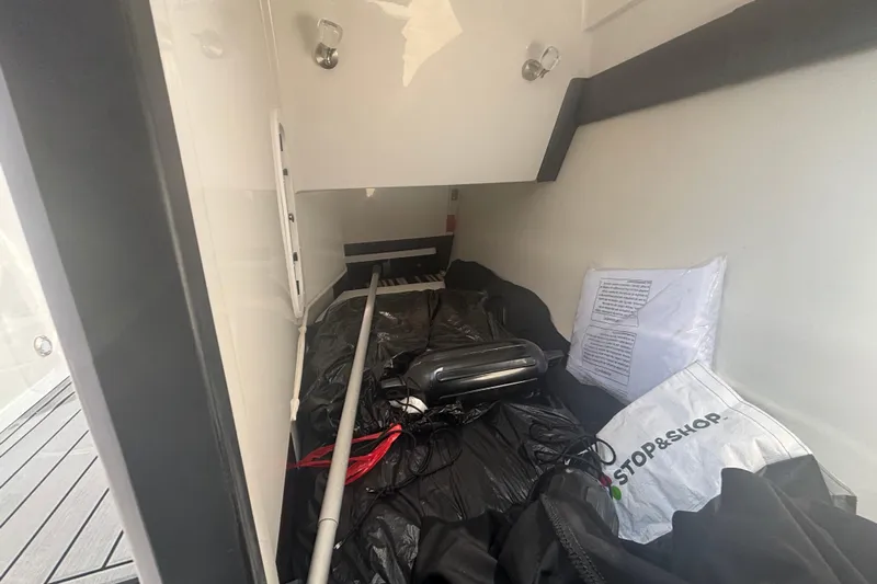  Yacht Photos Pics Storage compartment of 2018 Monterey 328SS Super Sport boat with various items inside.