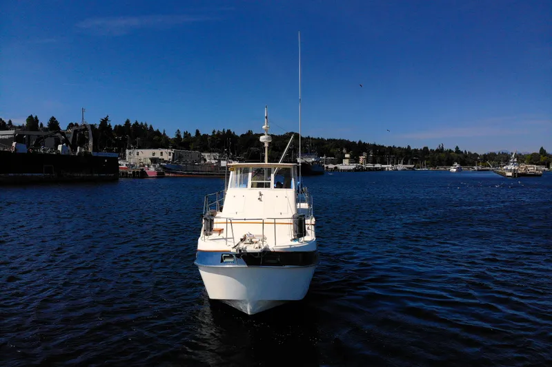 Amazing Grace Yacht Photos Pics 1983 Kadey-Krogen Manatee 36 boat on calm water, clear blue sky background.