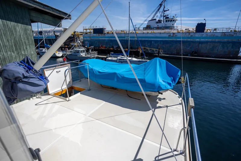Amazing Grace Yacht Photos Pics 1983 Kadey-Krogen Manatee 36 yacht deck with blue cover, docked in a marina.